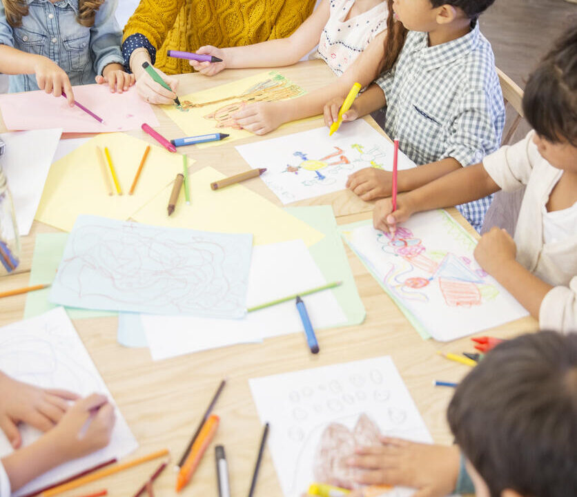 Students and teacher drawing in classroom